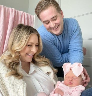 Hillary Vaughn and Peter Doocy with their kid